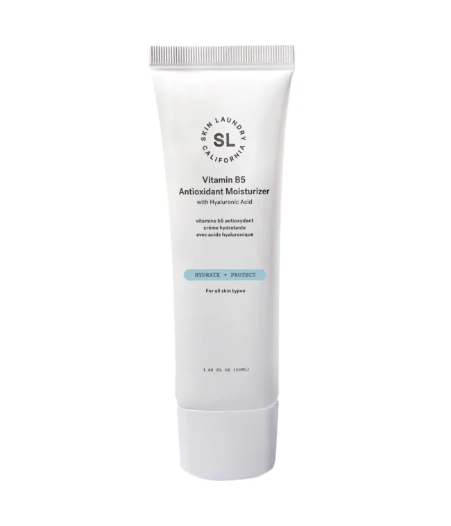 A white squeeze tube of Skin Laundry Vitamin B5 Antioxidant Moisturizer with Hyaluronic Acid, standing upright against a white background, highlighting its "HYDRATE + PROTECT" benefits for "all skin types."