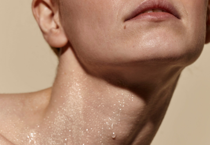 Close-up of dewy, radiant skin on the neck and jawline after a Skin Laundry UAE facial treatment