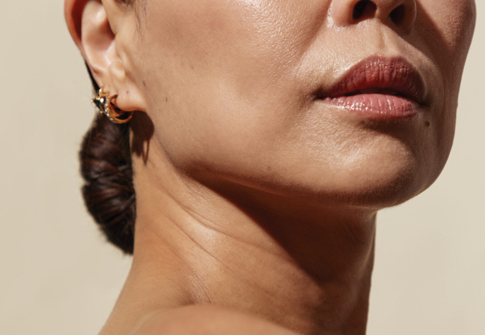 Close-up of a woman’s lower face and jawline highlighting smooth, even-toned skin after laser treatment