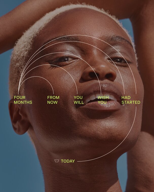 A person with short light-colored hair and dark skin looking up with a radiant expression. Overlaid text reads, "FOUR MONTHS FROM NOW YOU WILL WISH YOU HAD STARTED TODAY," with lines radiating from the face.